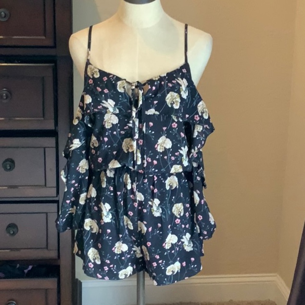 Size small black romper with flowers. Never worn. Brand new.
